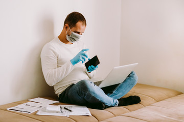 Obraz premium man with laptop and smartphone during quarantine at home