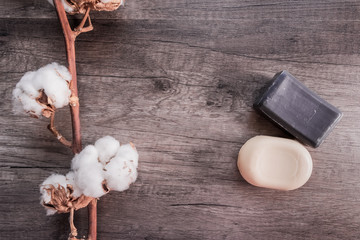 Soap and cotton on a structural background, the concept of cleanliness, tenderness, care, health and personal hygiene. Protection against infections and coronovirus