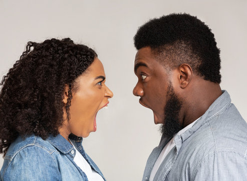 Relationship problems. Profile portrait of angry black couple arguing