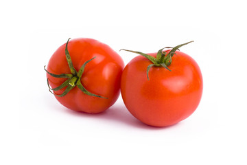 Fresh tomatoes isolated on white background. Two red ripe tomatoes isolated on white background. Tomatoes on white background.