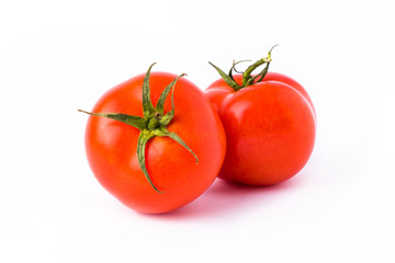 Fresh tomatoes isolated on white background. Two red ripe tomatoes isolated on white background. Tomatoes on white background.