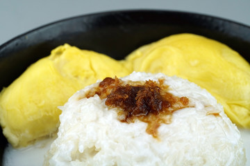 'Pulut Durian' is a glutinous or sticky rice with durian, coconut milk and sprinkle of grated palm sugar-selective focus