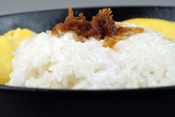'Pulut Durian' is a glutinous or sticky rice with durian, coconut milk and sprinkle of grated palm sugar-selective focus