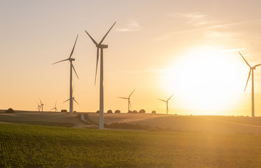 Wind turbines/power plants at sunset. 