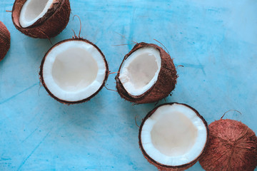 top view layout of fresh coconuts on a blue background