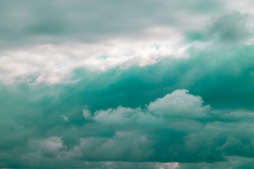 Toned in mint color clouds close-up. Dark gray clouds on a rainy day. Natural background.