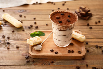 Tasty tiramisu on wooden table