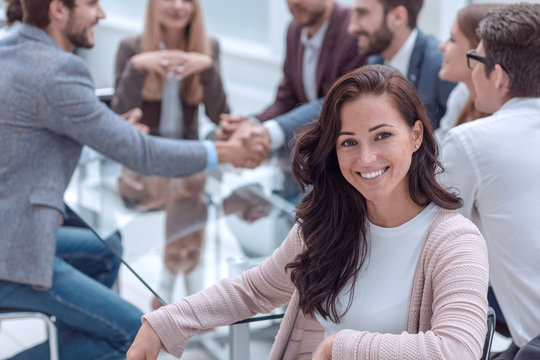 smiling business woman sitting in front of the table in the meeting room