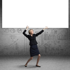 Beautiful woman in suit standing near banner