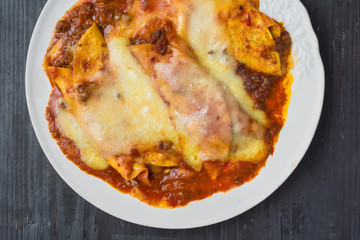 rustic messy cheesy american mexican beef enchiladas