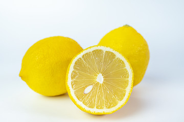 Sliced fresh lemon for summer drink on white background.