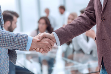 close up. handshake of business men on the office background