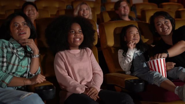 People audience watching movie in the movie theater cinema. Group recreation activity and entertainment concept.