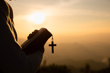 Hands of a Christian man holding a bible while praying to God, Religious beliefs, Copy space.