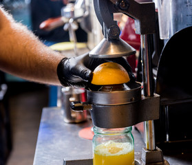 Metal manual juicer. Preparation of freshly squeezed orange juice