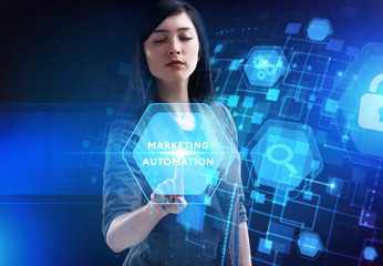 Business, Technology, Internet and network concept. Young businessman working on a virtual screen of the future and sees the inscription: Marketing automation