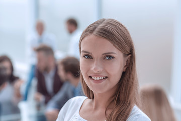 portrait of a successful young woman on the background of the office