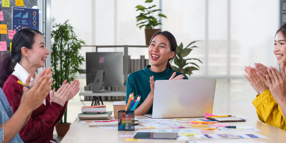 Poster asian female leader and ux/ui designer clapping hand for successful of mobile app interface wirefram