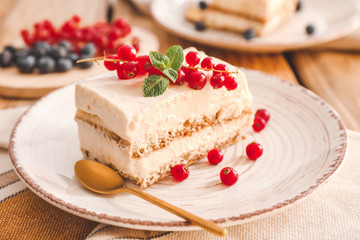 Plate with tasty tiramisu on table