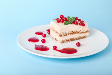Plate with tasty tiramisu on color background