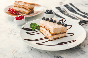 Plate with tasty tiramisu on white background