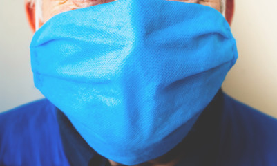 Fototapeta premium Elderly man in medical mask for hygiene and protection against coronavirus. Close-up