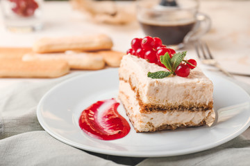Plate with tasty tiramisu on table