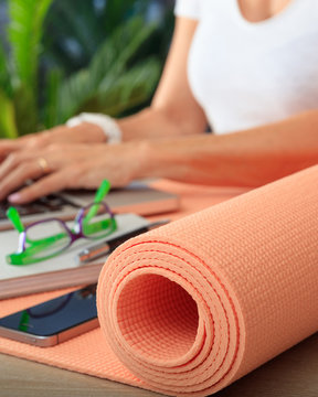 Woman and an exercise mat, corporate office background