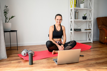 Woman doing fitness at home with video tutorial