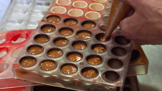Putting praline filling in mold