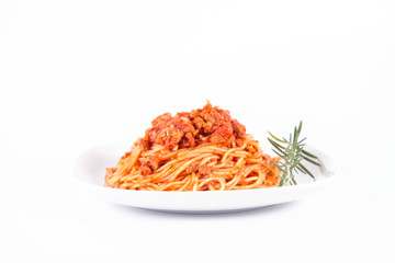 Spaghetti bolognese on a plate	 decorated with a rosemary twig