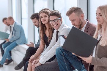 young business people sitting in the office corrido