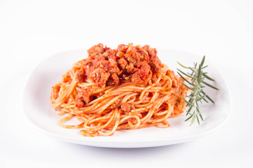 Spaghetti bolognese on a plate	 decorated with a rosemary twig