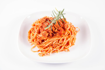 Spaghetti bolognese on a plate	 decorated with a rosemary twig