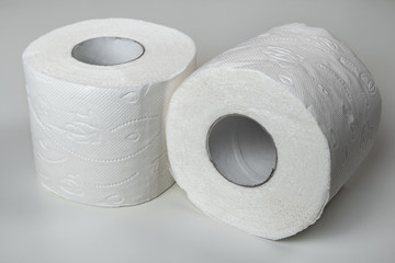 Twoo rolls of white rolled toilet paper closeup