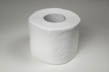 Single roll of white rolled toilet paper closeup