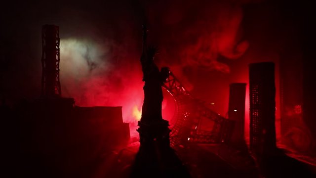 Empty street of burnt up city, flames on the ground and blasts with smoke in the distance. Apocalyptic view of city downtown as disaster film poster concept. Night scene. City destroyed by war.