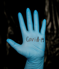 Hand of a woman in a medical glove. Coronavirus outbreak concept
