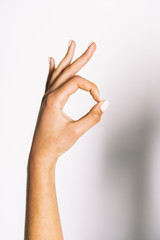 multiracial hand showing OK sign