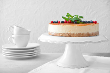 Tasty cheesecake with berries on table