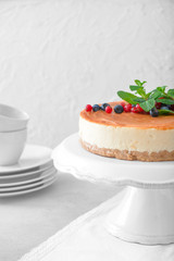 Tasty cheesecake with berries on table