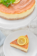 Plate with piece of tasty cheesecake on table