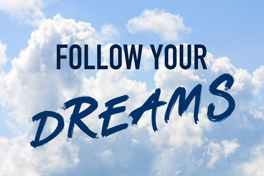 Phrase follow your dreams on a blue clouded sky