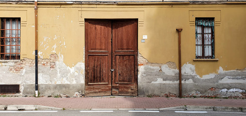 Old abandoned house with wood locked gate with chain