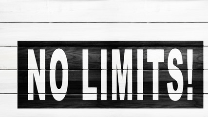 no limits, motivation and inspiration slogan, white text on a wooden background