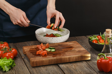 Woman cooking fresh vegetable salad. Female hands. Diet concept for healthy lifestyle with copyspace.