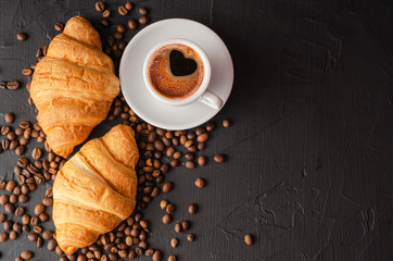 Coffee white cup, croissants on dark  background. Breakfast concept