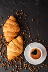 Coffee white cup, croissants on dark  background. Breakfast concept