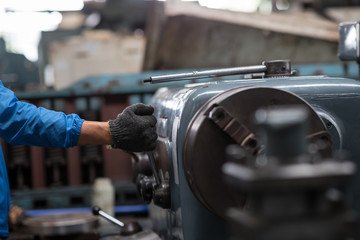 Close-up of hand worker working with a manufacturing machinery