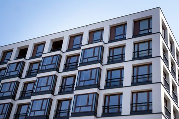 Urban lifestyle. Facade of new modern residential house. Apartment building in the city. 